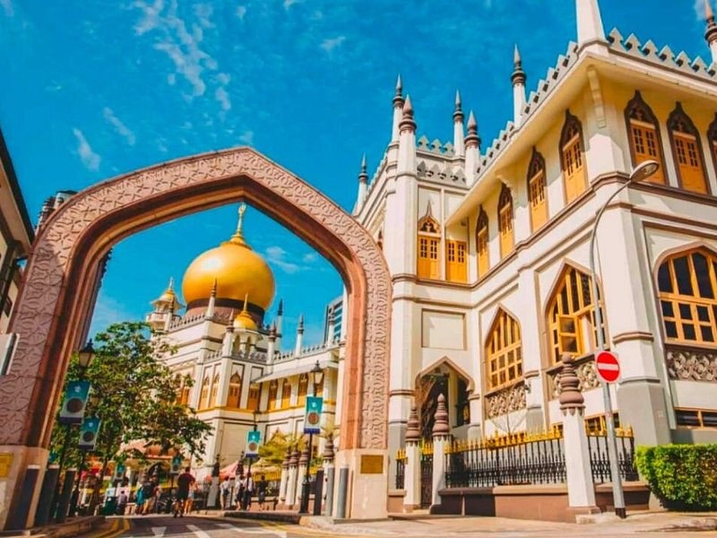 The golden dome of the Sultan Mosque framed by the archway on Muscat Street in Kampong Glam